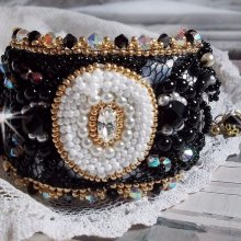 Bracelet Noir Sacré Haute Couture brodé avec des cristaux : navette, hélix Bead,, toupies, breloque fleur strassée,  perles rondes nacrées Verre et rocailles. Les couleurs sont le Noir, Blanc et Doré